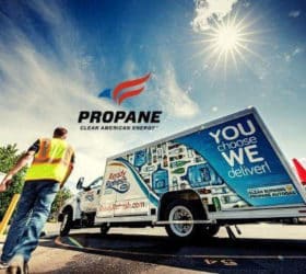 Propane specialist walking by propane truck