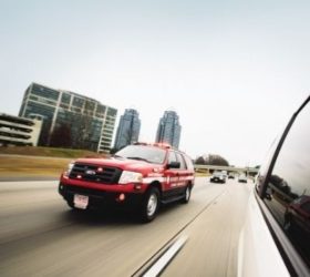 Propane autogas emergency medical services SUV driving down a highway by a city