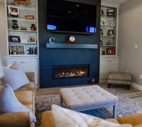 A living room with a propane fireplace burning