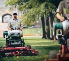 man riding propane mowers