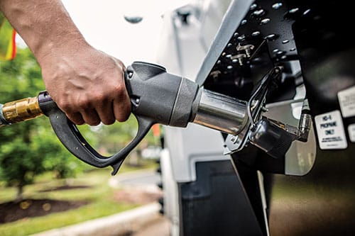 A propane autogas quick connect nozzle fueling a vehicle