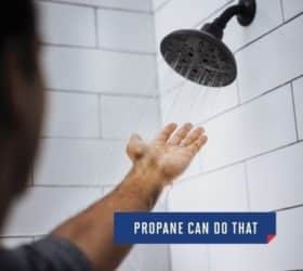 Person sticking their hand into water from a shower head
