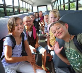 Elementary school kids in a school bus