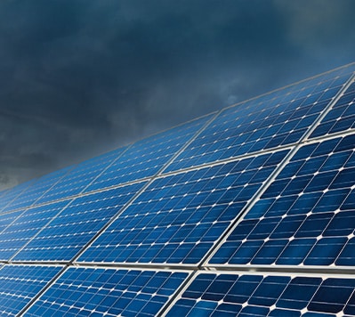 Solar panels against a stormy sky